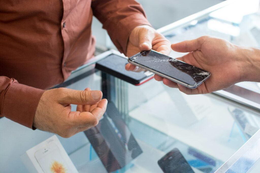 Customer and staff checking a phone at the counter